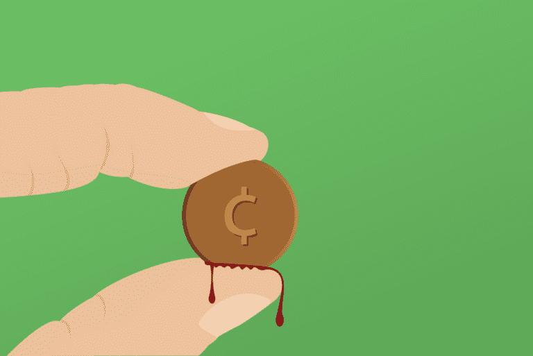 a hand holding a coin with a symbol and blood on it