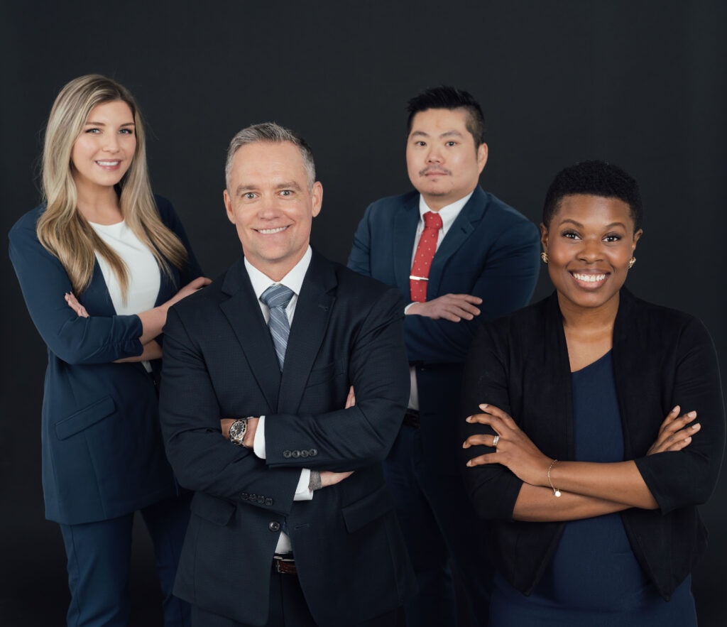 Snellings Law Employees posing on a dark background