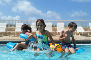 a group of kids playing in a pool