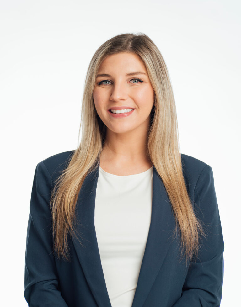 a woman with long blonde hair wearing a suit