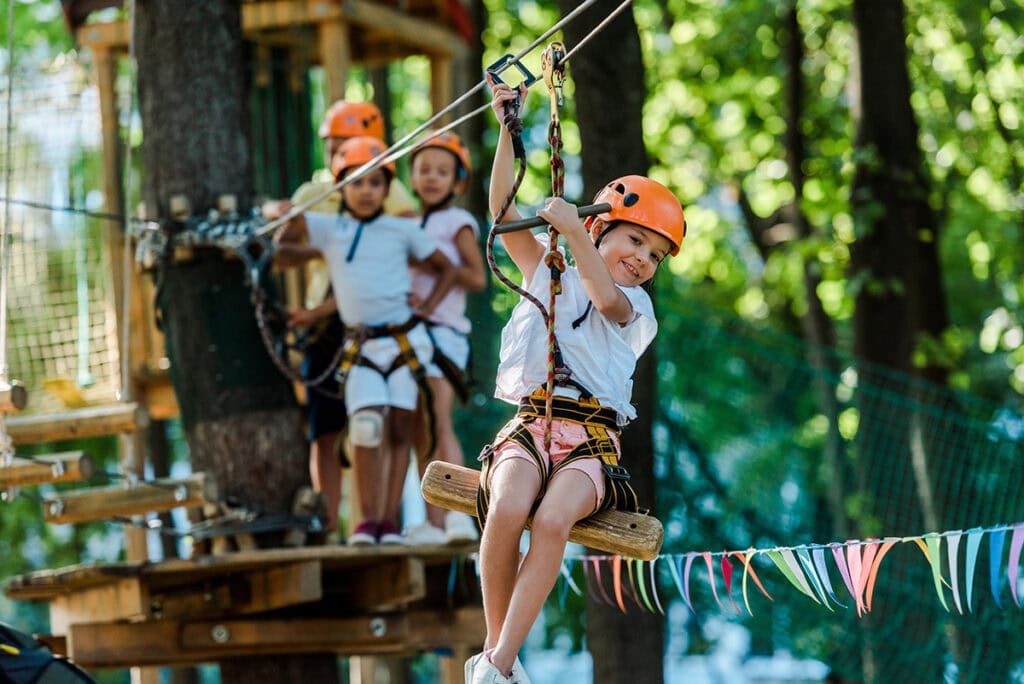 a group of kids in a rope park