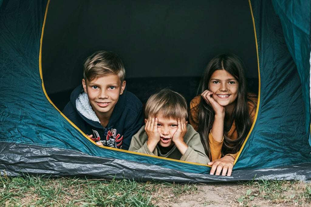 a group of kids in a tent