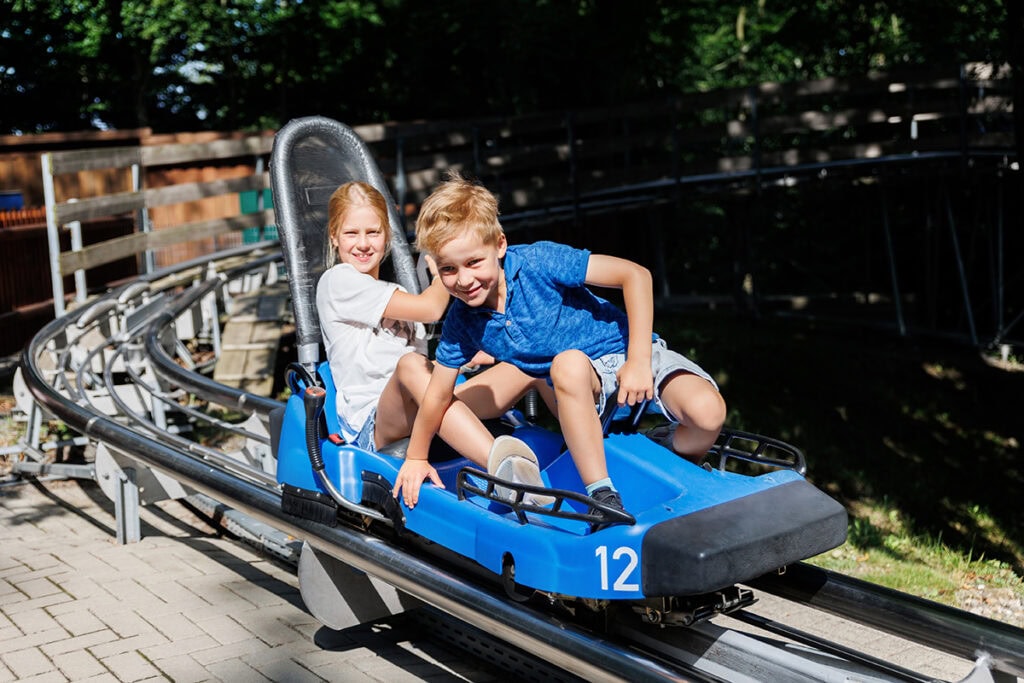 a boy and girl on a roller coaster