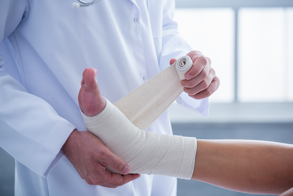 a doctor bandaging a foot