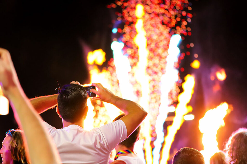 a man taking a picture of fireworks