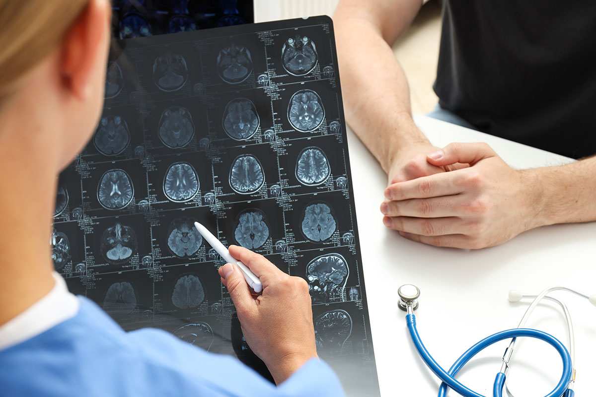 a young female doctor is looking at an mri image of a patient