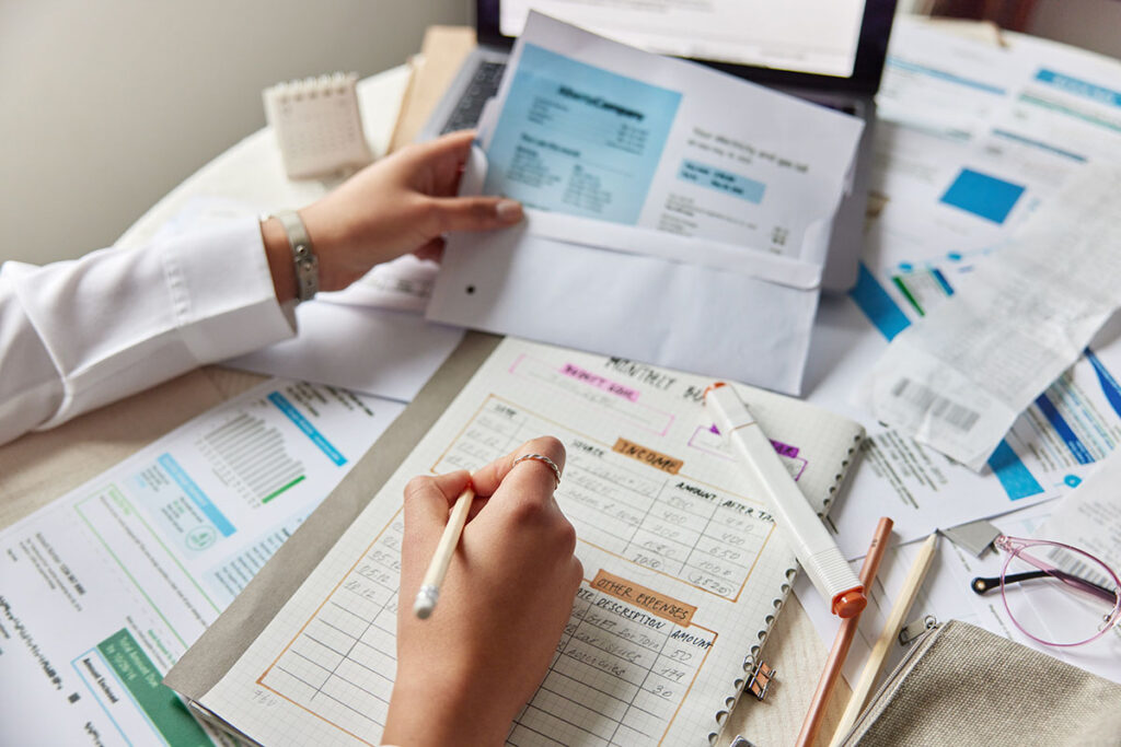 cropped view of unknown woman sits at desktop with medical documents
