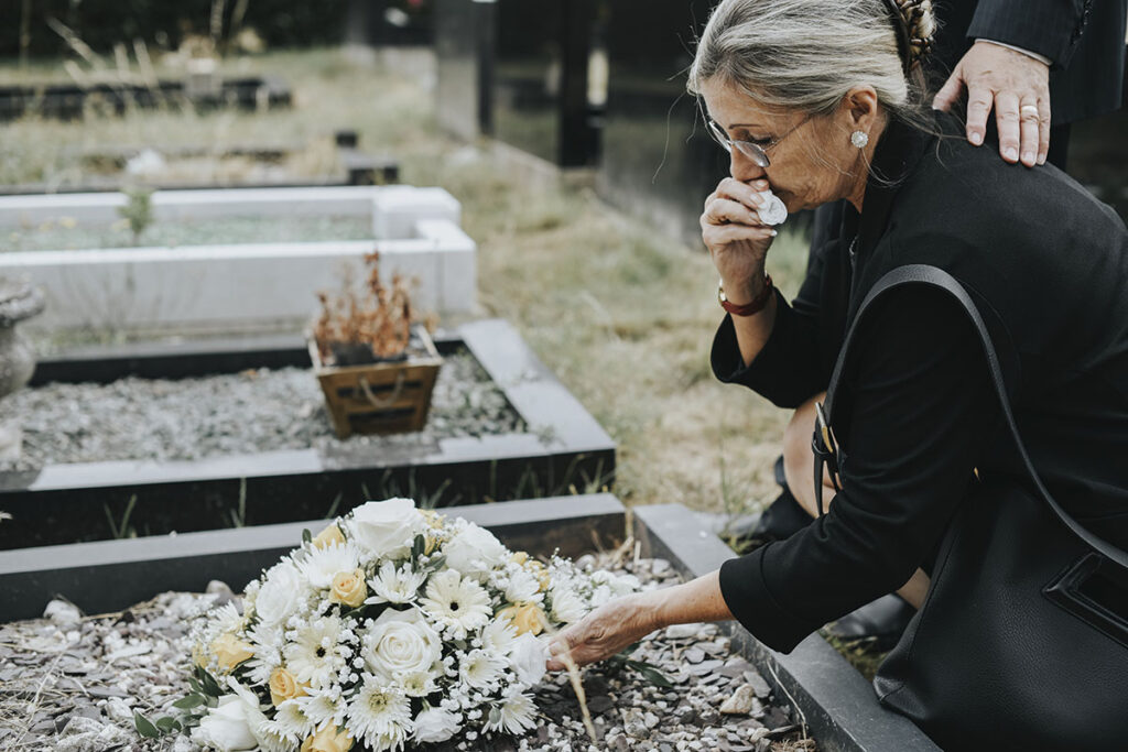 old woman laying flowers on a grave 2025 02 10 01 32 22 utc copy