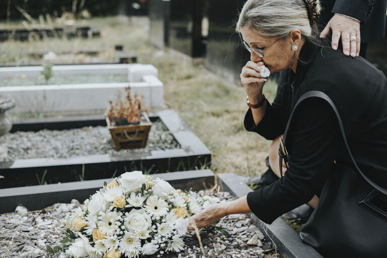 old woman laying flowers on a grave 2025 02 10 01 32 22 utc copy