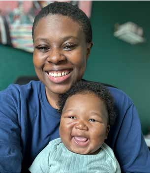 A smiling woman holding a laughing baby