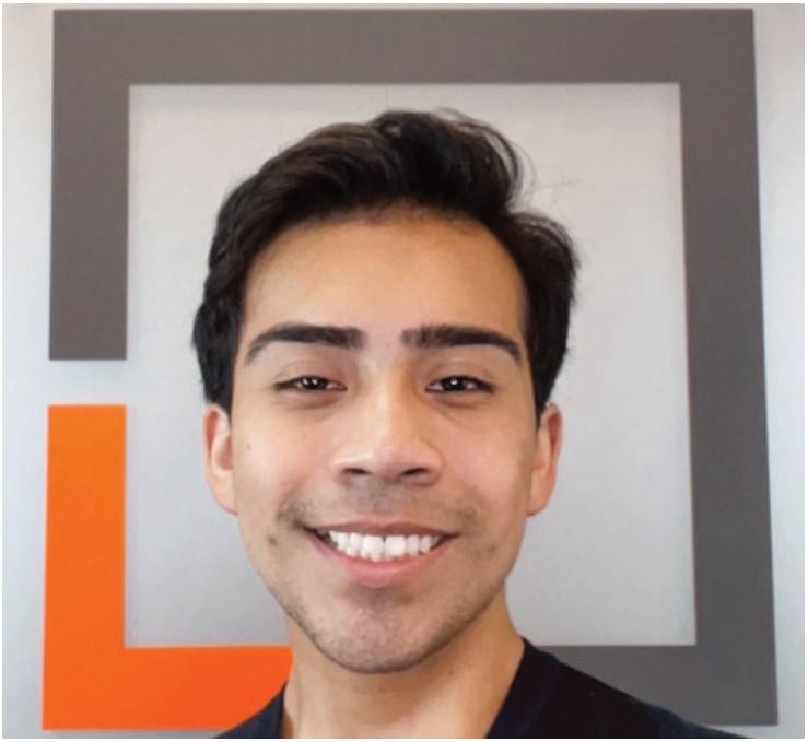 Ricardo Oviedo smiling in front of the Snellings Law logo