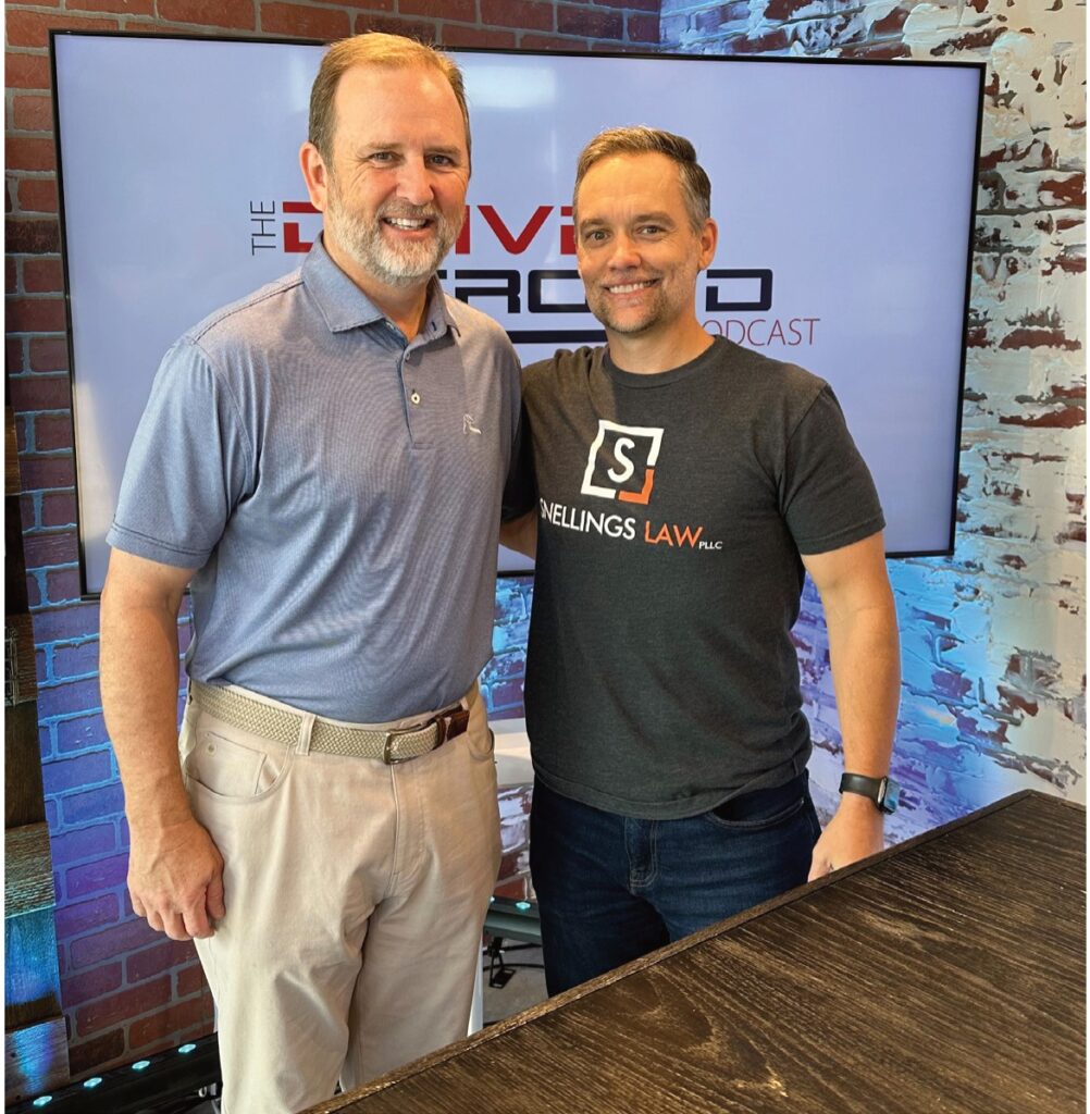 Two men standing together on the set of The Driven Crowd podcast