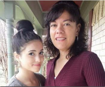 Two women smiling together on a front porch