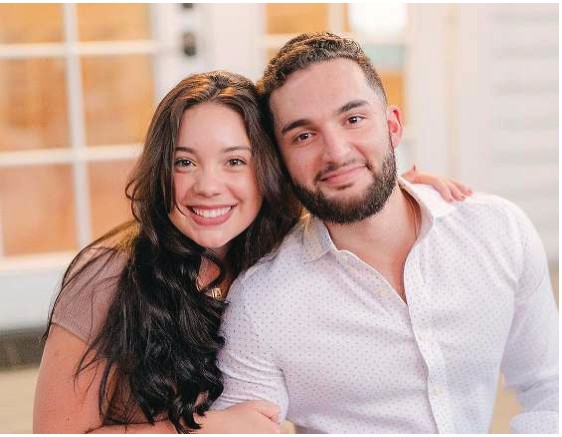 A smiling young couple posing together