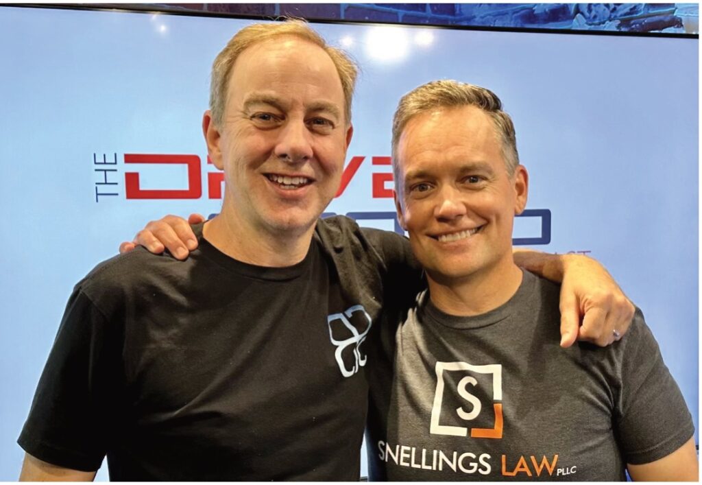 Two men in Snellings Law and Driven Crowd shirts posing on the podcast set