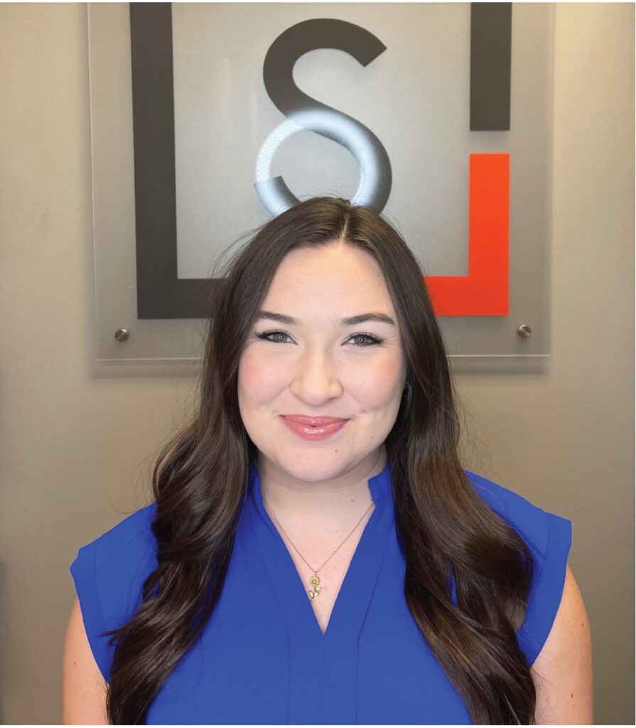 Case manager Morgan smiling in front of the Snellings Law logo
