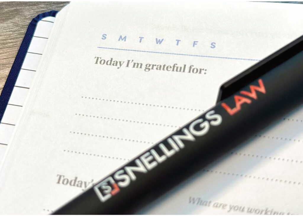 A Snellings Law pen resting on a gratitude journal page that reads Today I'm grateful for