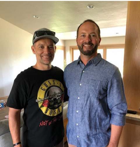 Two men smiling together in a living room